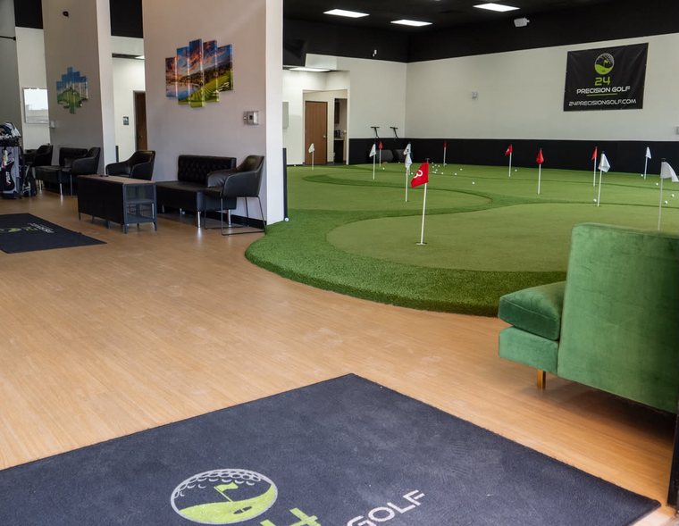 The lounge and putting green seen across the studio floor
