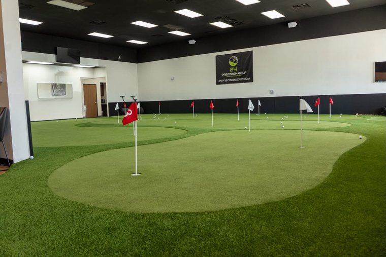 The putting green with practice flags across its contours